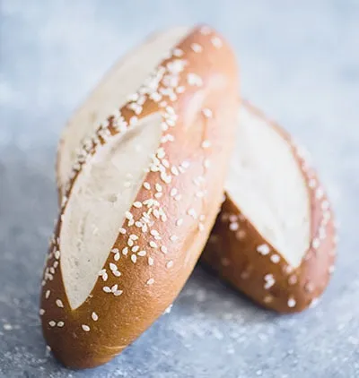 Two sesame-topped pretzel rolls